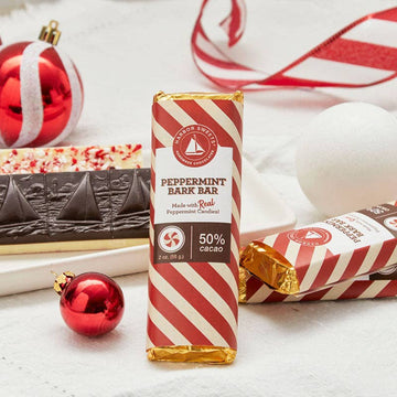 Peppermint Chocolate Bark Bar on a whie table with Christmas decorations