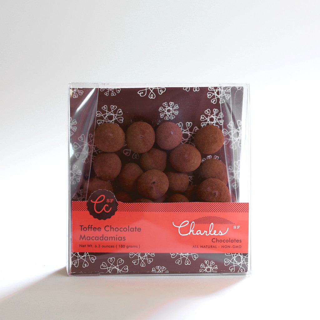 Toffee Chocolate Macadamias in clear packaging. from Charles Chocolates, against a white background.