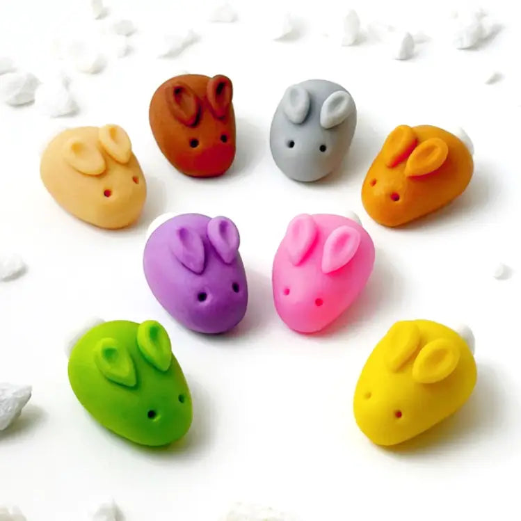 Eight unwrapped Marzipan Easter Bunnies on a white table