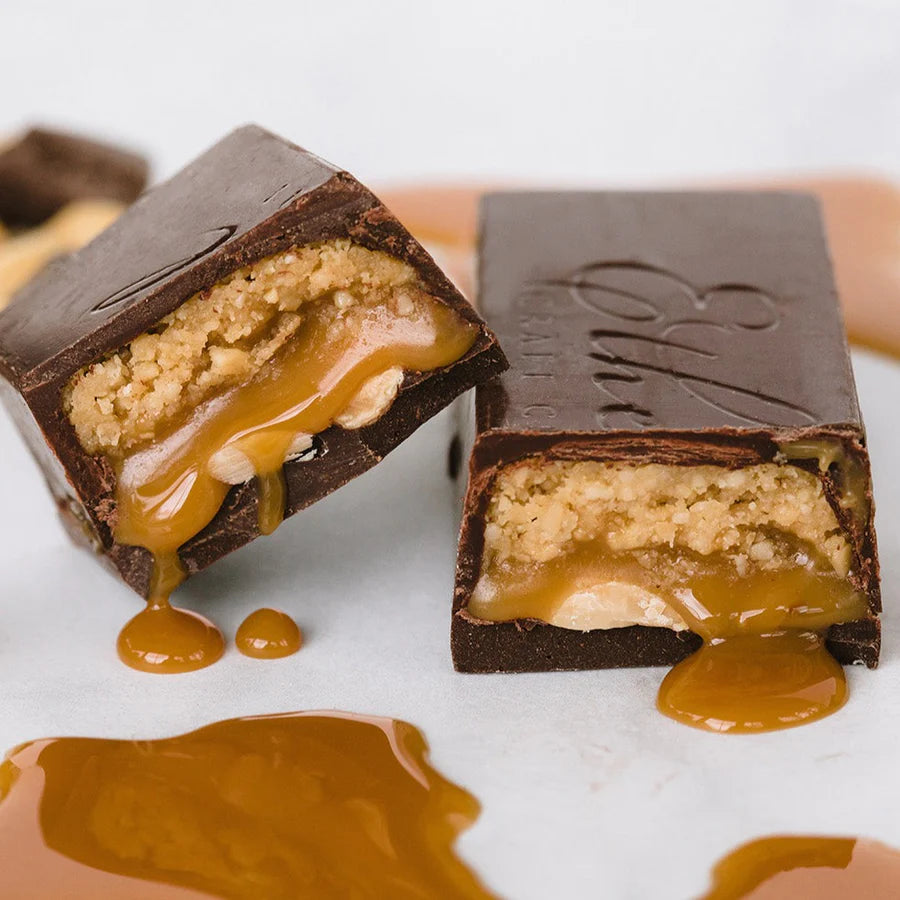 Two unwrapped pieces of Sidekick candy bar on a white table